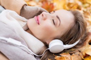 Woman in headphones listening to audio